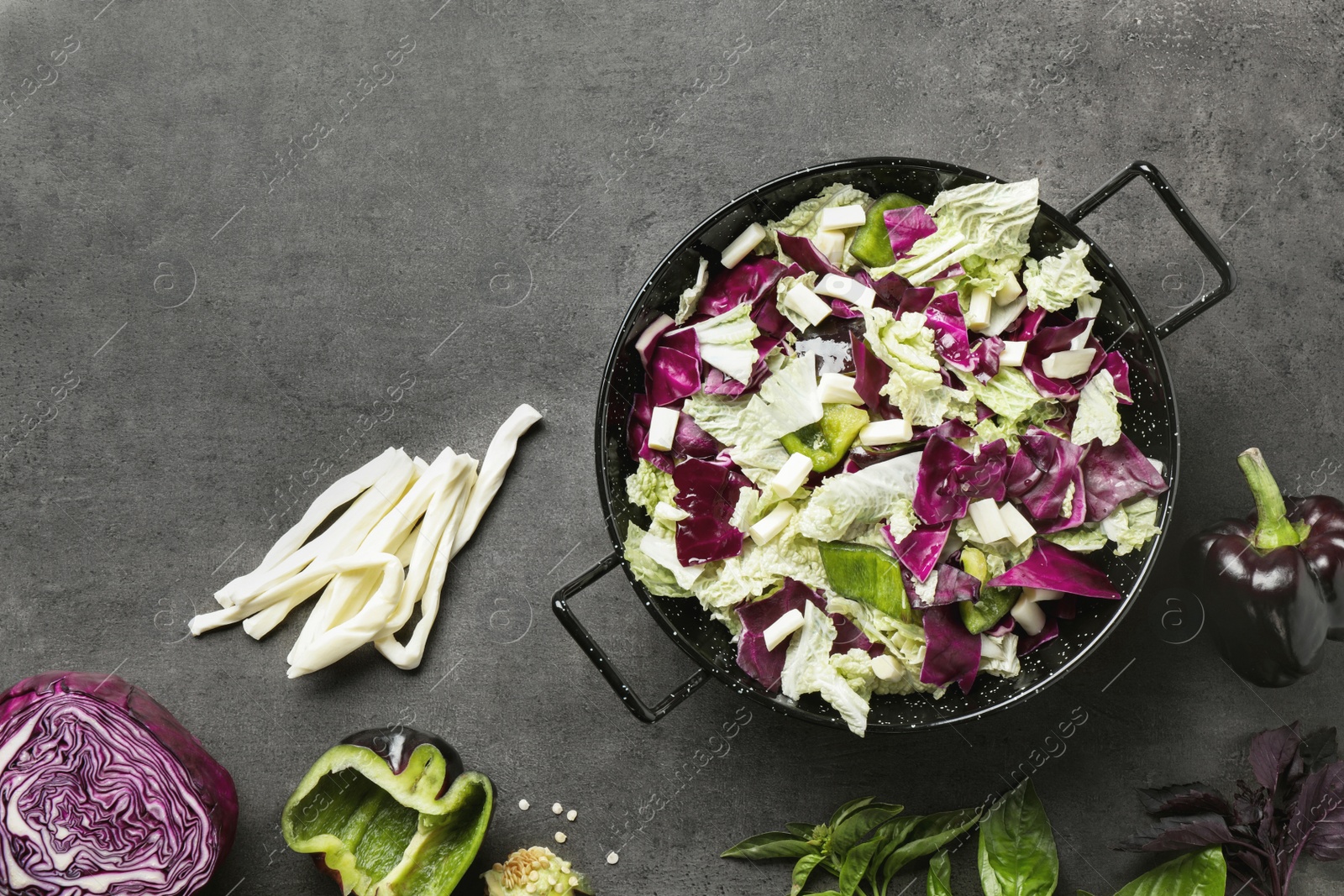 Photo of Delicious salad with Chinese cabbage, suluguni cheese and bell pepper on grey table, flat lay. Space for text