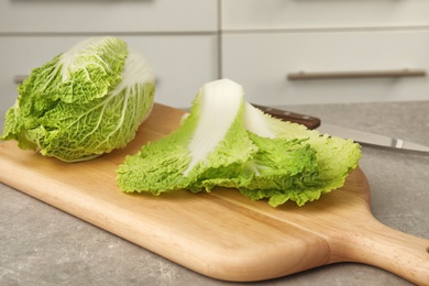 Wooden board with fresh ripe cabbage on table. Healthy food