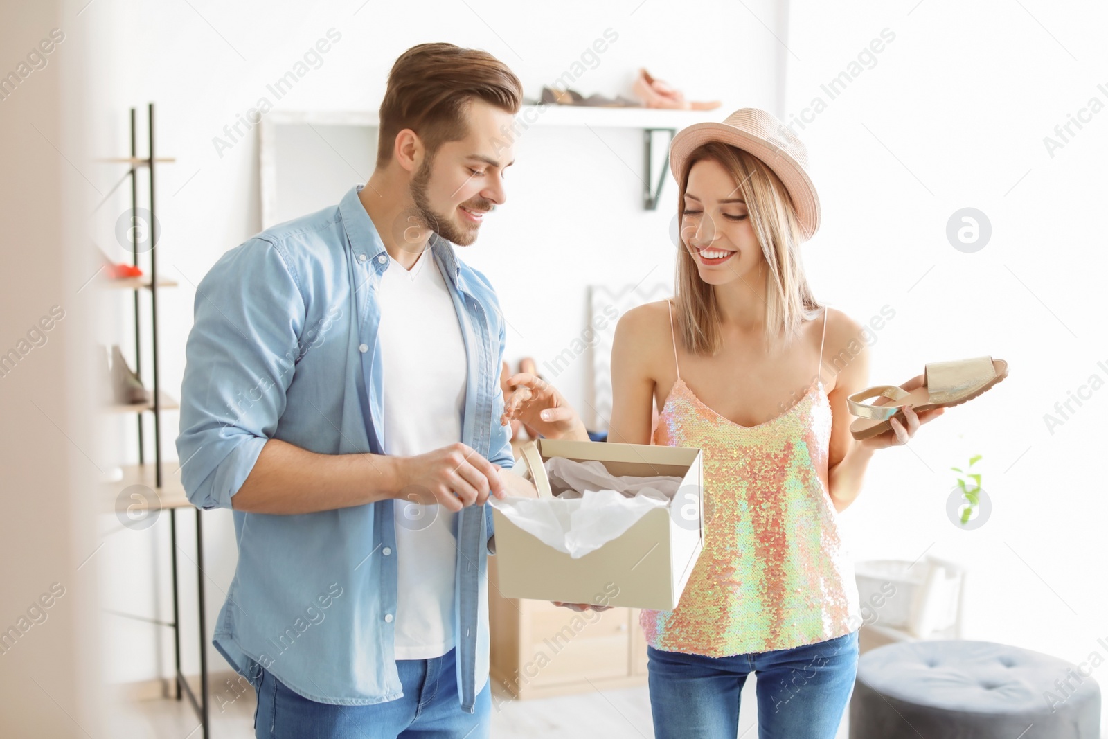 Photo of Young couple choosing shoes in store