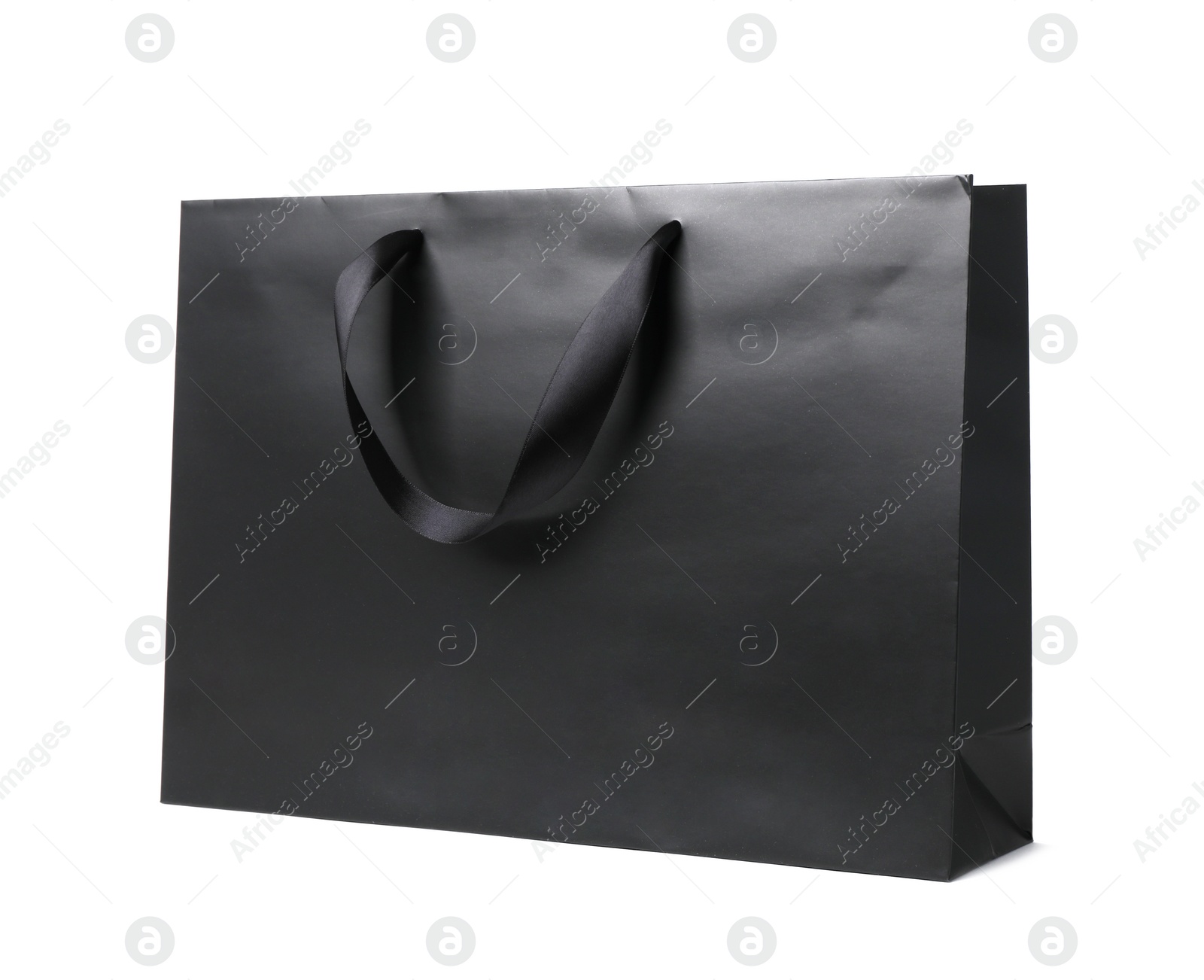 Photo of Paper shopping bag with ribbon handles on white background. Mockup for design