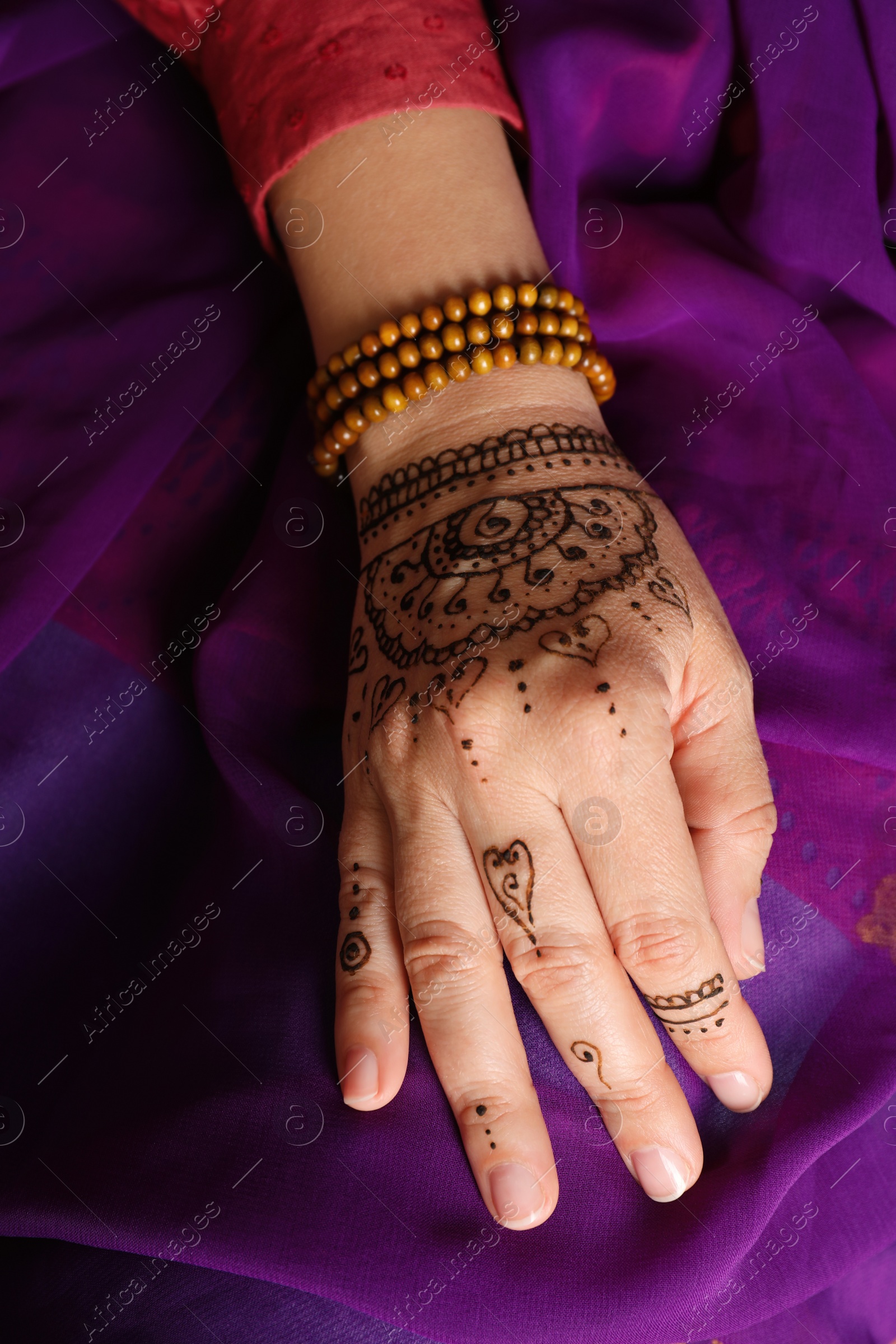 Photo of Woman with beautiful henna tattoo on hand, closeup. Traditional mehndi