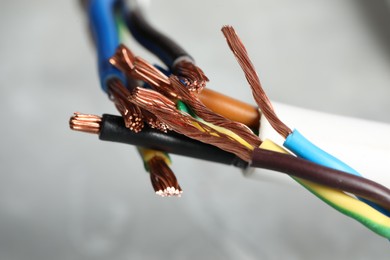 Photo of Colorful electrical wires on gray background, closeup