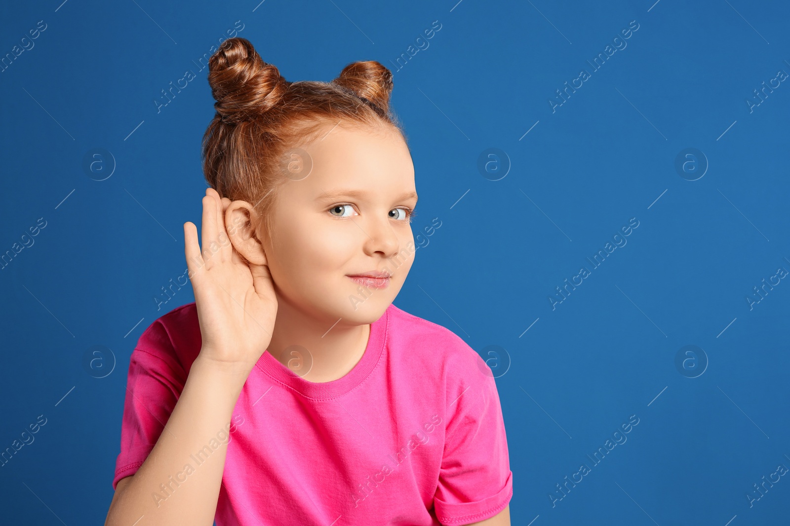 Photo of Portrait of emotional girl on blue background. Space for text