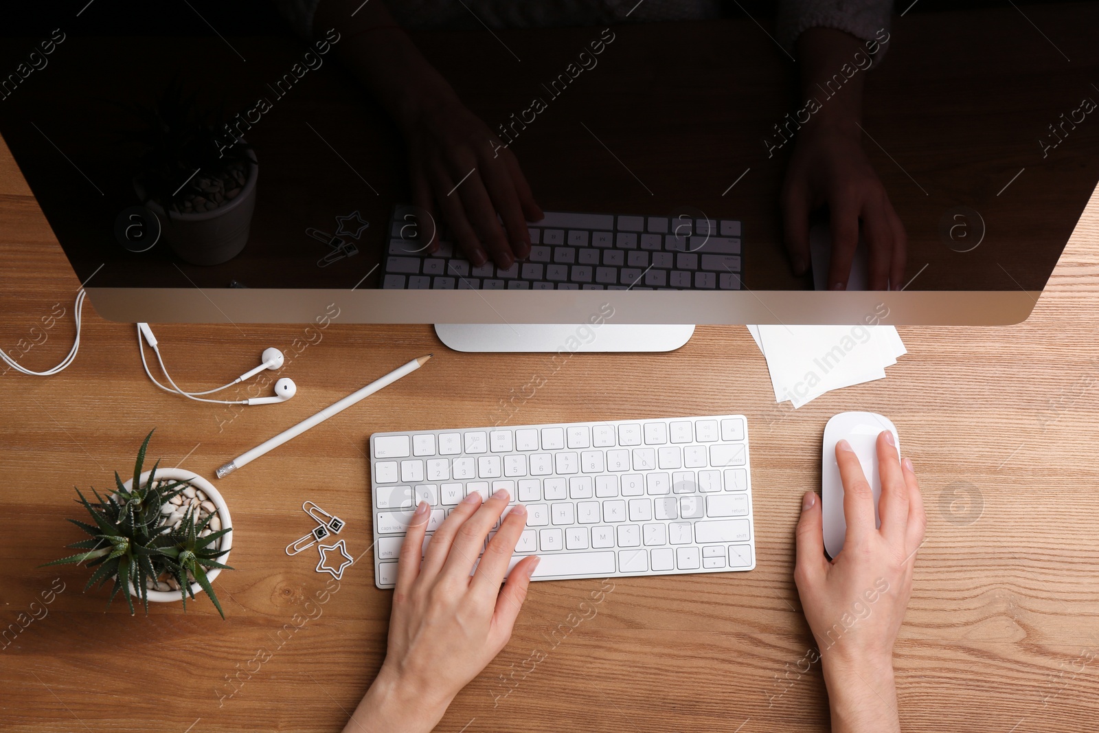 Photo of Woman using computer mouse and keyboard at office table, top view