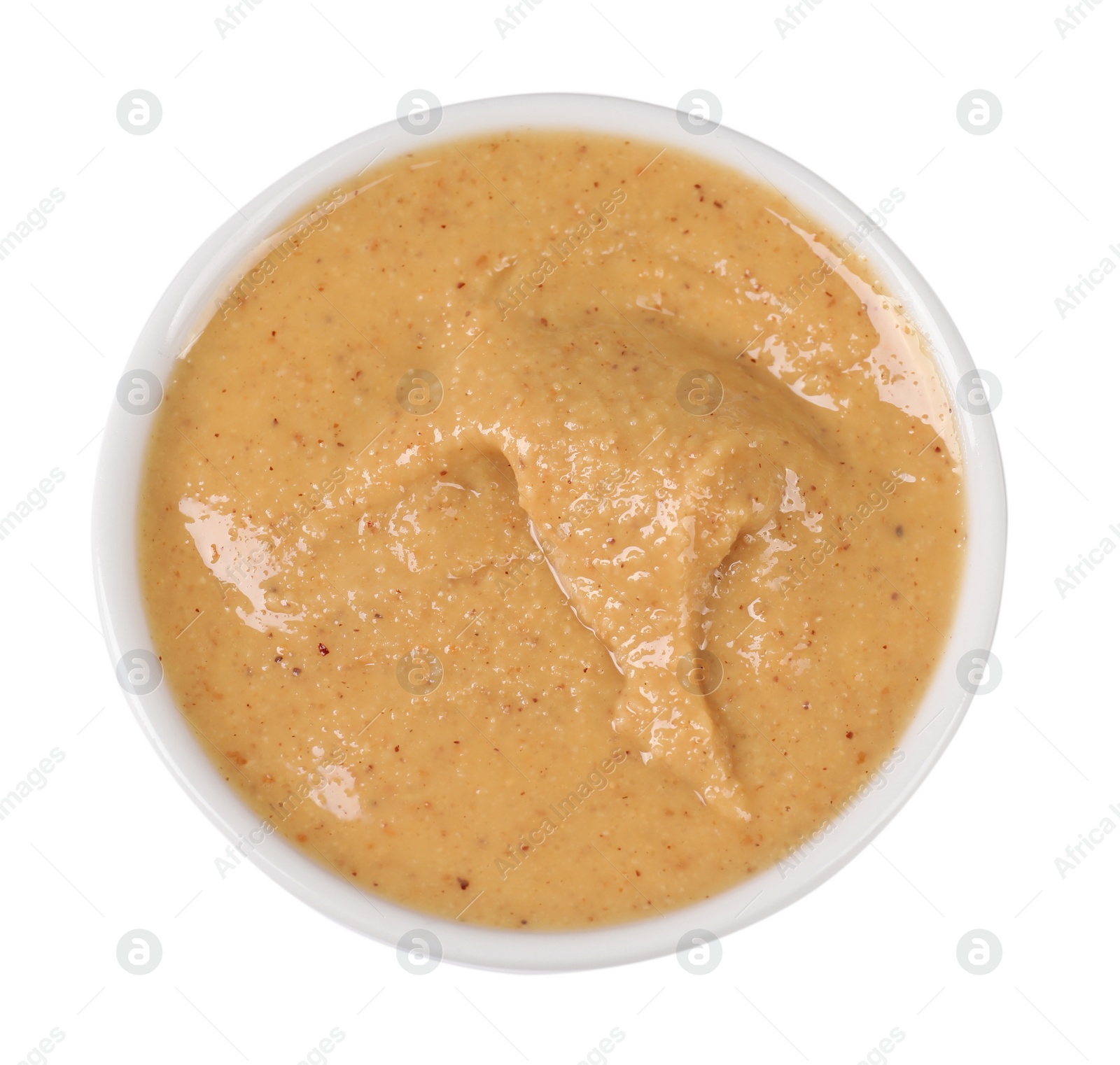 Photo of Delicious nut butter in bowl isolated on white, top view