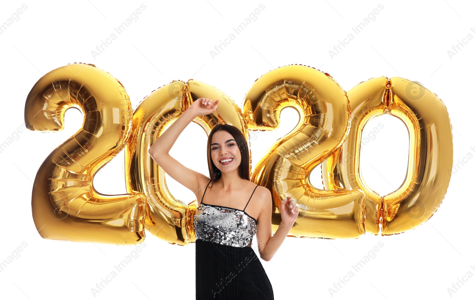 Photo of Happy young woman with golden 2020 balloons on white background. New Year celebration