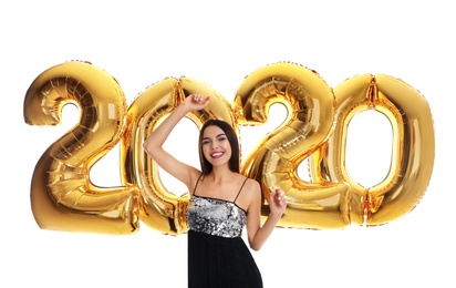 Happy young woman with golden 2020 balloons on white background. New Year celebration