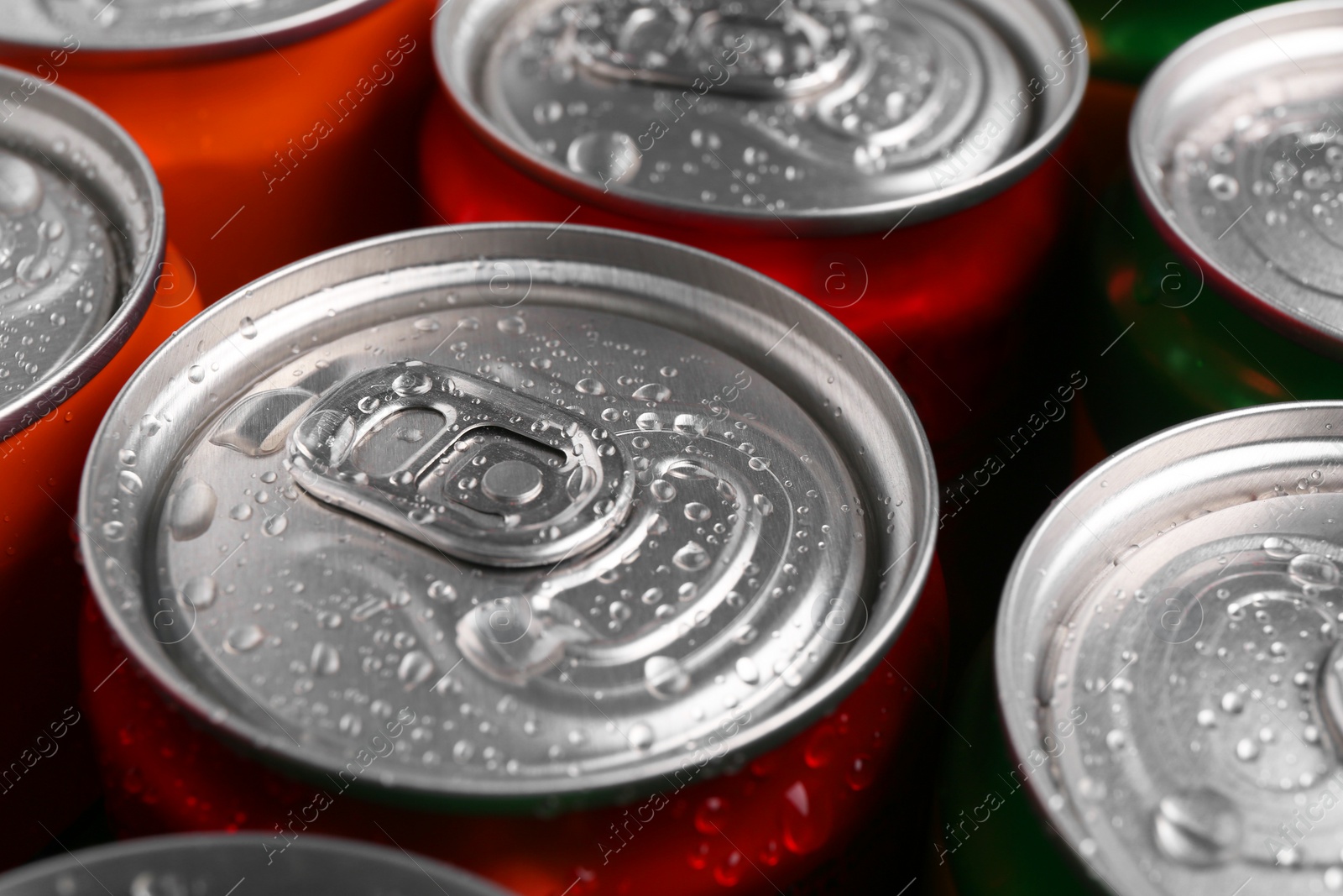 Photo of Energy drinks in wet cans, closeup. Functional beverage