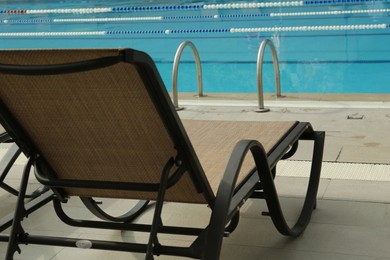 Photo of Sunbed near swimming pool at luxury resort
