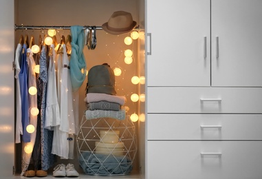 Photo of Women clothing on hangers in wardrobe