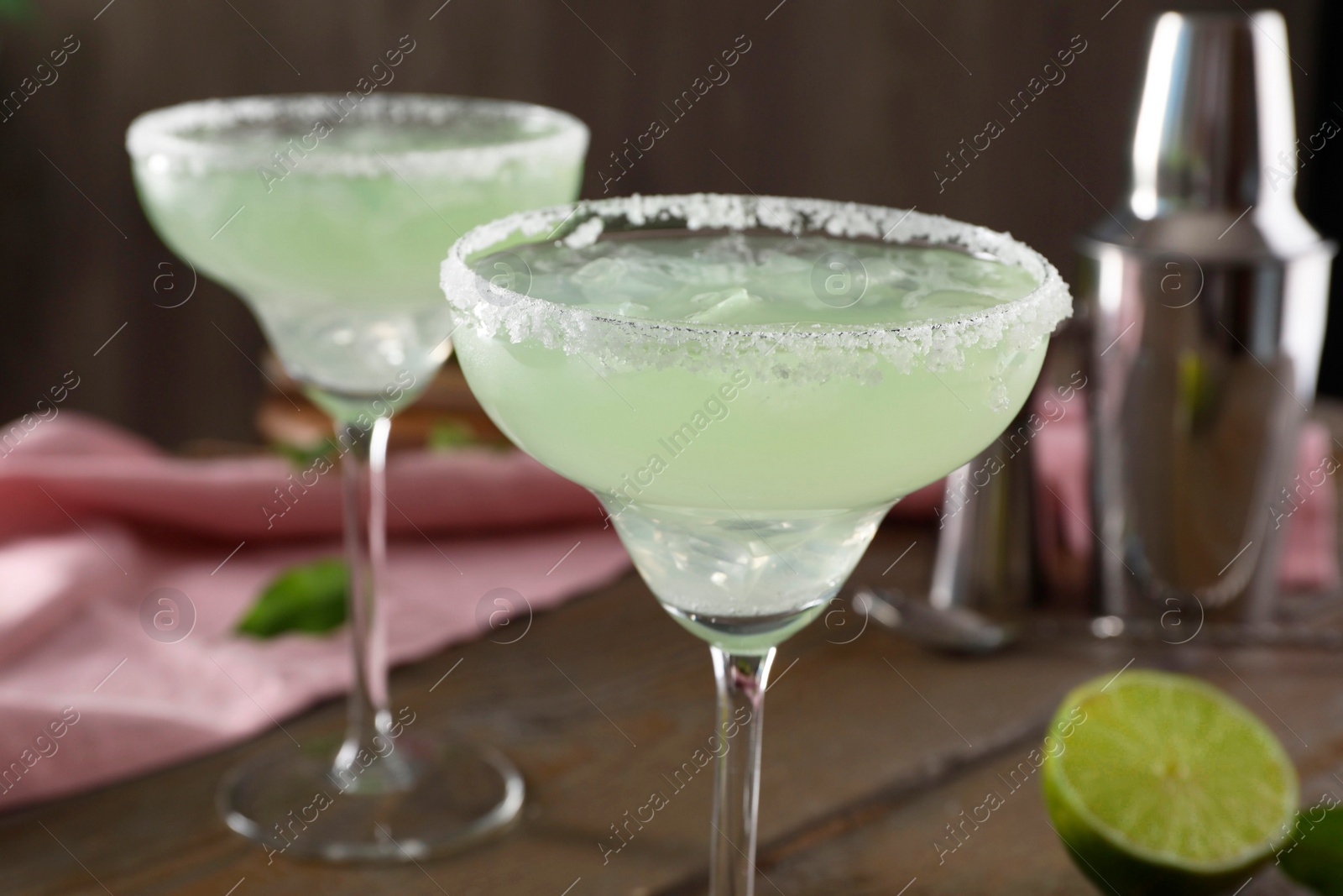 Photo of Delicious Margarita cocktail in glasses on table, closeup