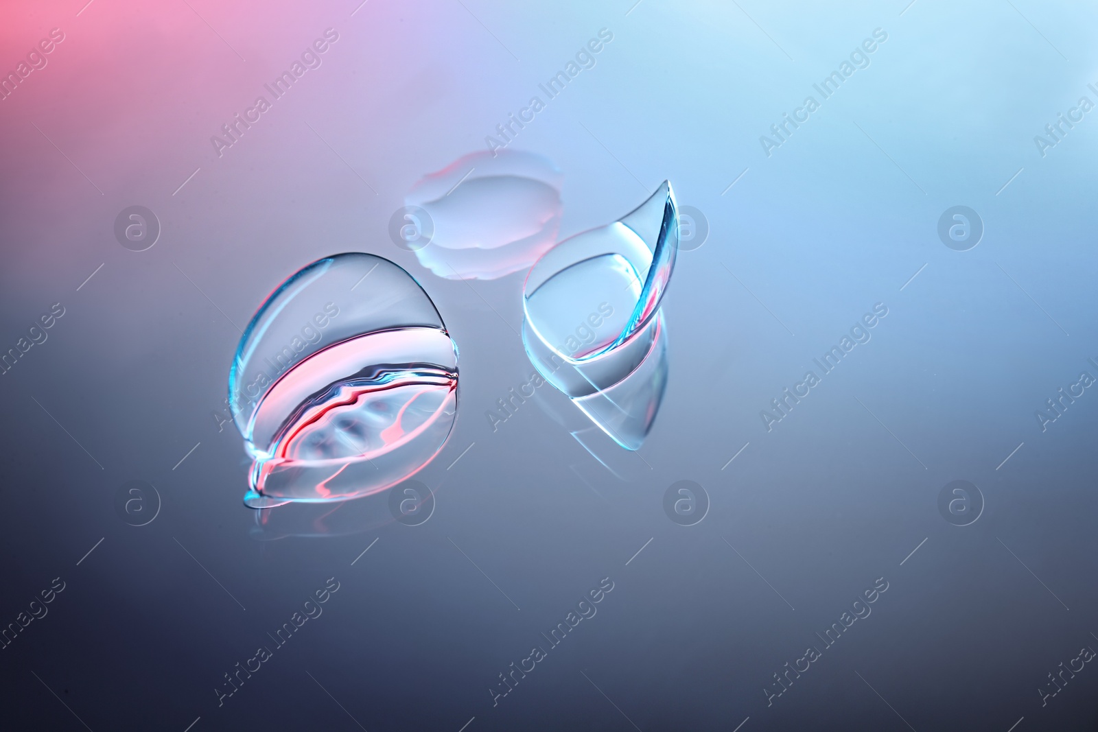 Photo of Contact lenses on color glass background