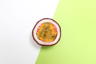 Half of tasty passion fruit (maracuya) on color background, top view