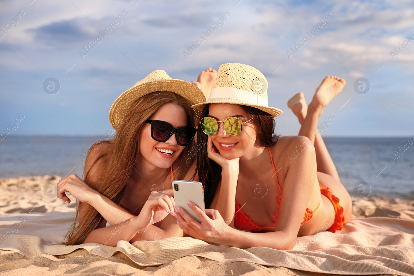 Photo of Young couple in bikini spending time together on beach