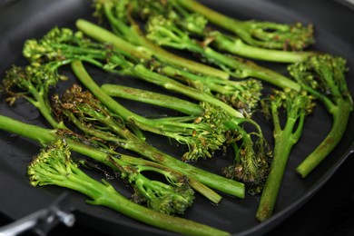 Grill pan with tasty cooked broccolini, closeup