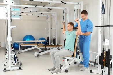 Photo of Patient exercising under physiotherapist supervision in rehabilitation center