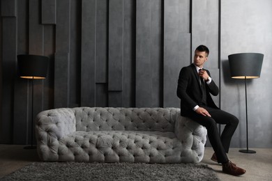 Photo of Handsome businessman in stylish living room. Luxury lifestyle