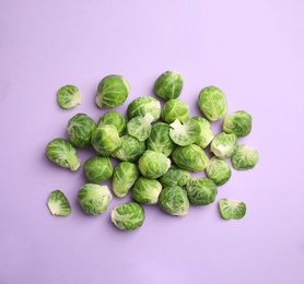 Fresh Brussels sprouts on violet background, flat lay