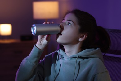 Photo of Girl with can of energy drink at home