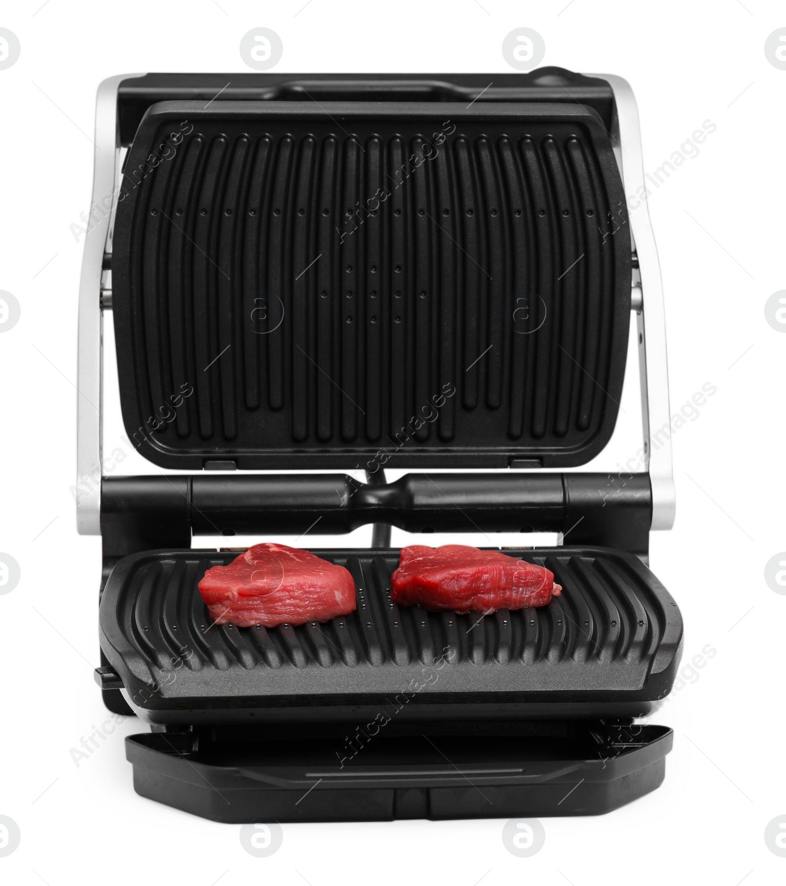 Photo of Electric grill with raw meat steaks isolated on white