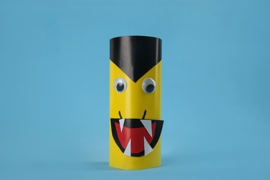 Funny yellow monster on light blue background. Halloween decoration
