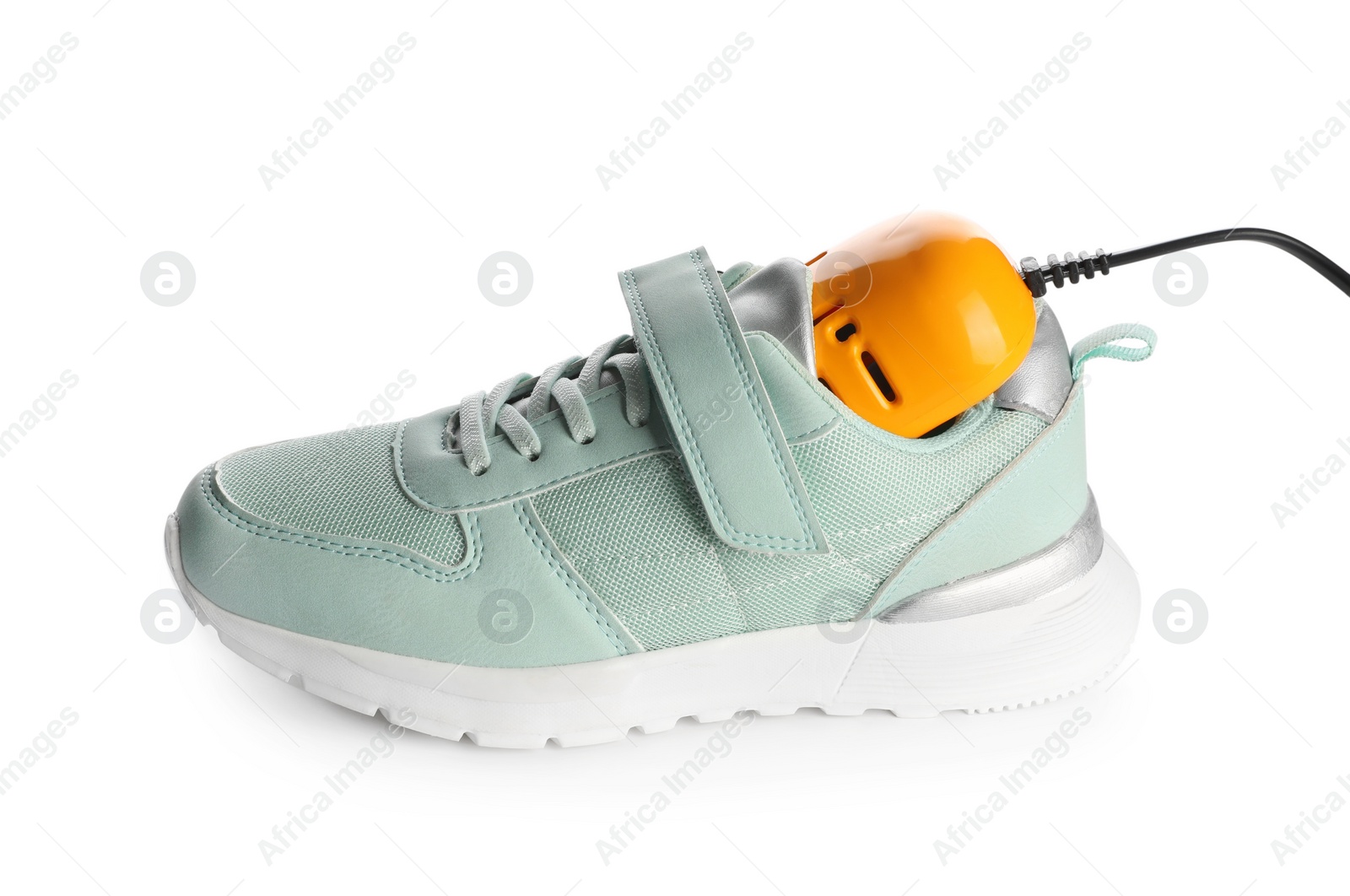 Photo of Stylish sneaker with modern electric shoe dryer on white background