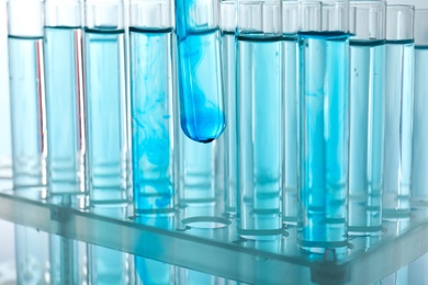 Photo of Taking test tube with liquid sample, closeup