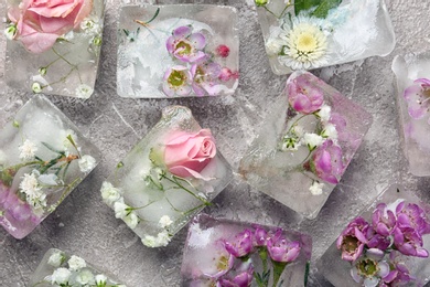 Floral ice cubes on table, flat lay