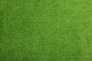 Photo of Green artificial grass as background, top view