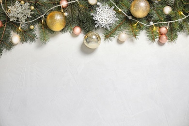 Photo of Christmas decoration on white stone background, flat lay. Space for text