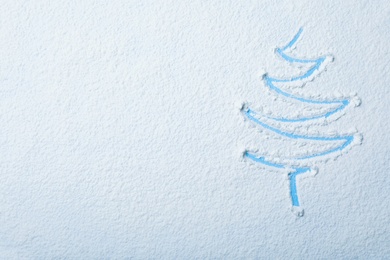 Christmas tree silhouette in snow on color background, top view with space for text