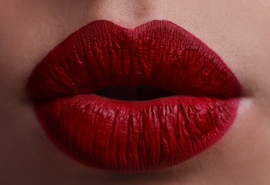 Photo of Closeup view of beautiful woman puckering lips for kiss