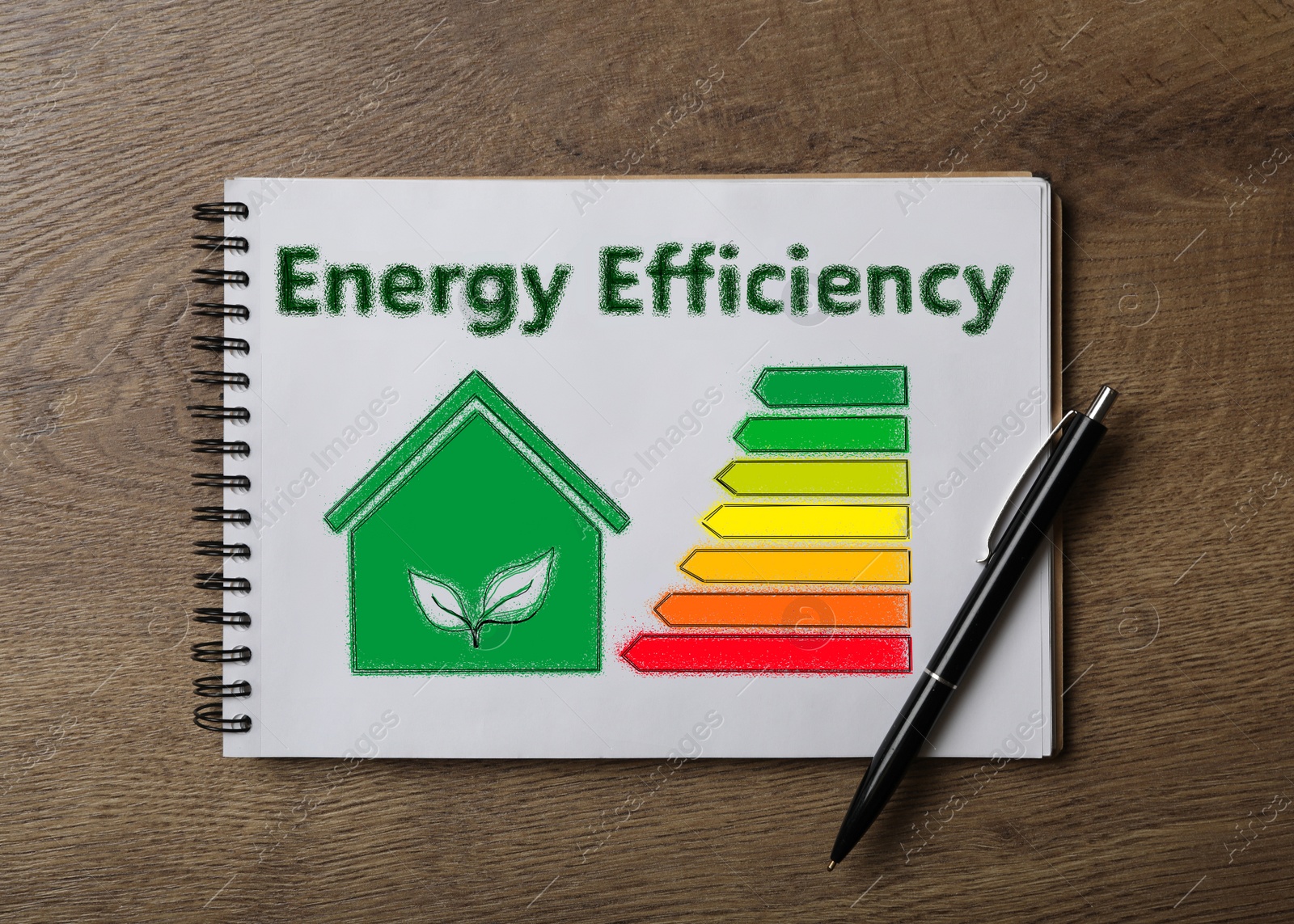 Image of Energy efficiency concept. Notebook with drawn house and chart on wooden table, top view