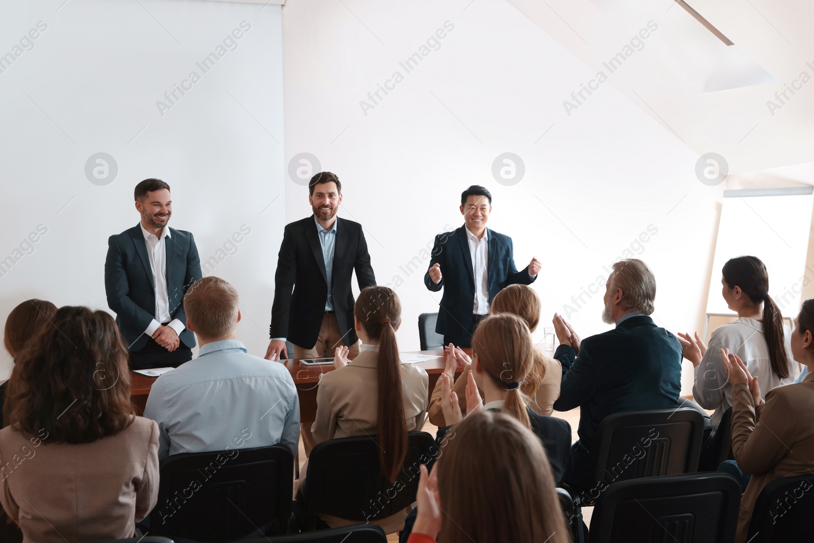 Photo of Business conference. People in meeting room listening to speaker report