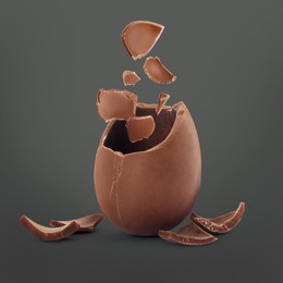 Image of Exploded milk chocolate egg on dark grey background