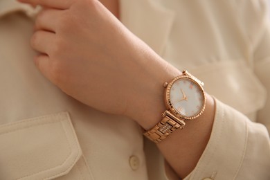 Photo of Woman in casual shirt with luxury wristwatch, closeup