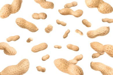 Image of Unpeeled peanuts in air on white background