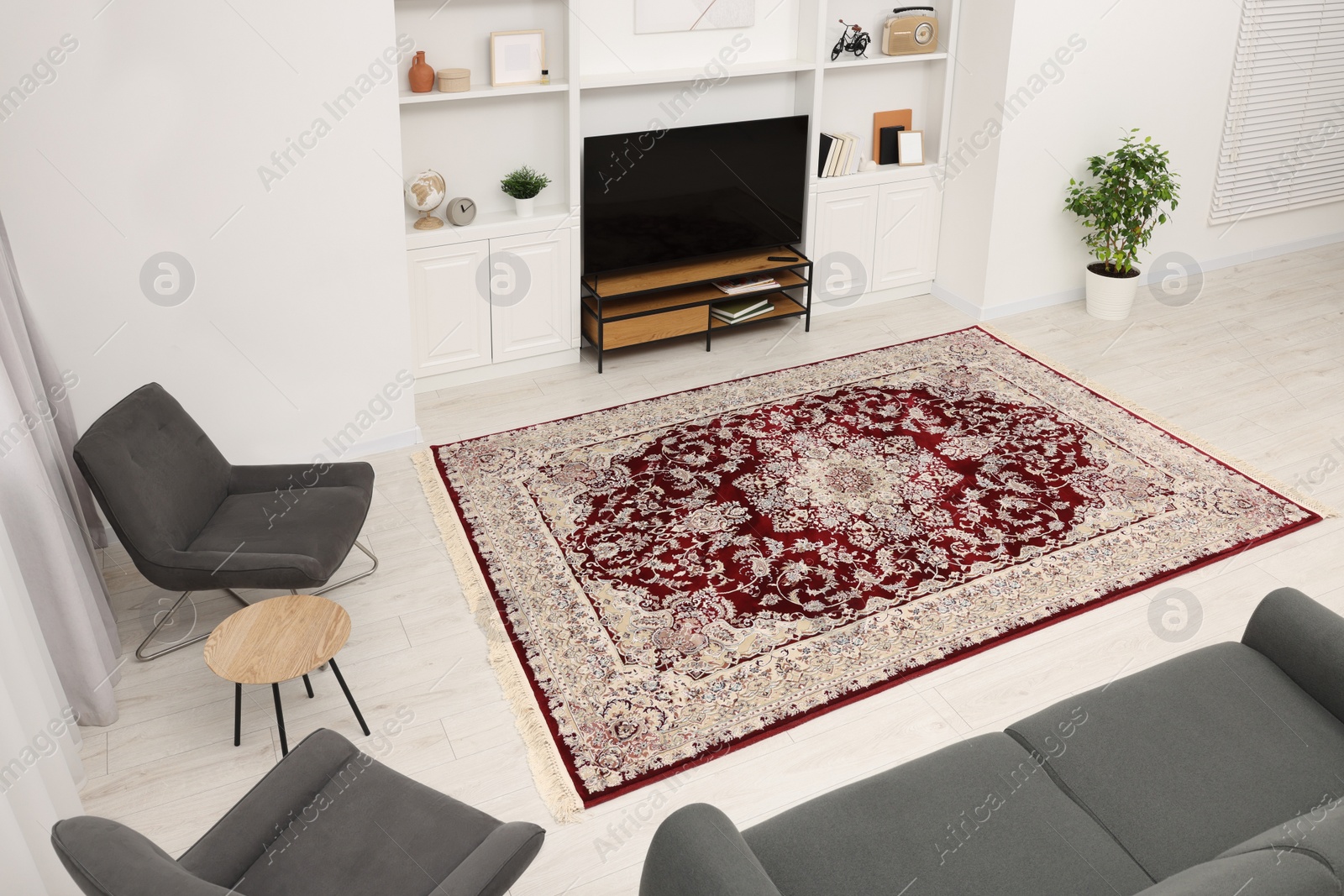 Photo of Stylish room with beautiful rug and furniture, above view. Interior design