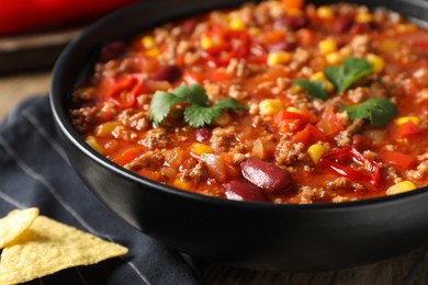 Photo of Bowl with tasty chili con carne, closeup view