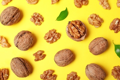 Flat lay composition with walnuts on color background