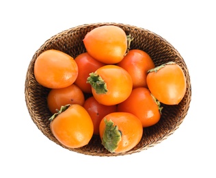 Wicker bowl with delicious persimmons isolated on white, top view