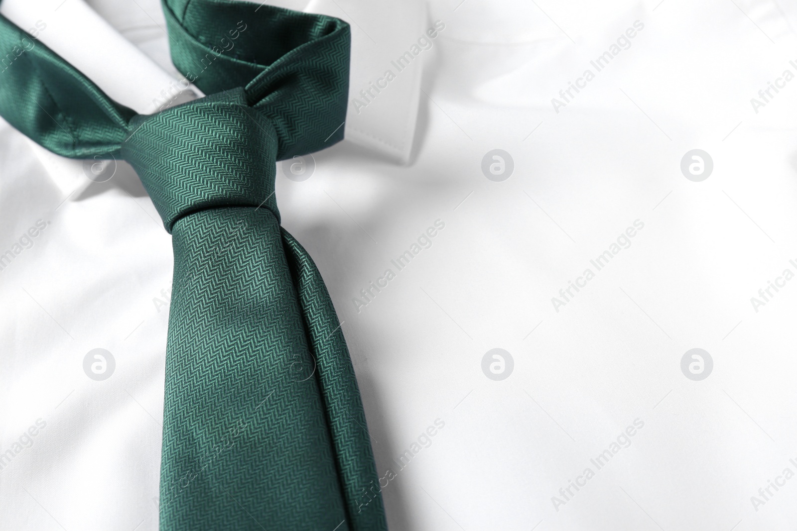 Photo of Color male necktie on white shirt, closeup. Space for text