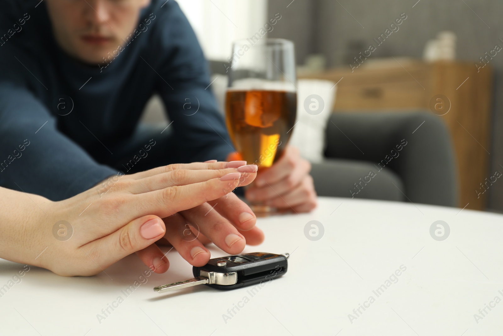 Photo of Woman stopping drunk man from taking car keys, closeup. Don't drink and drive concept