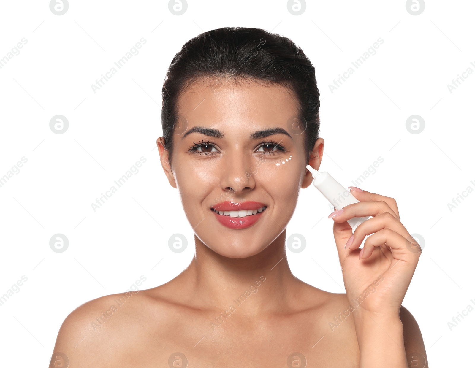 Photo of Woman applying cream under eyes on white background. Skin care