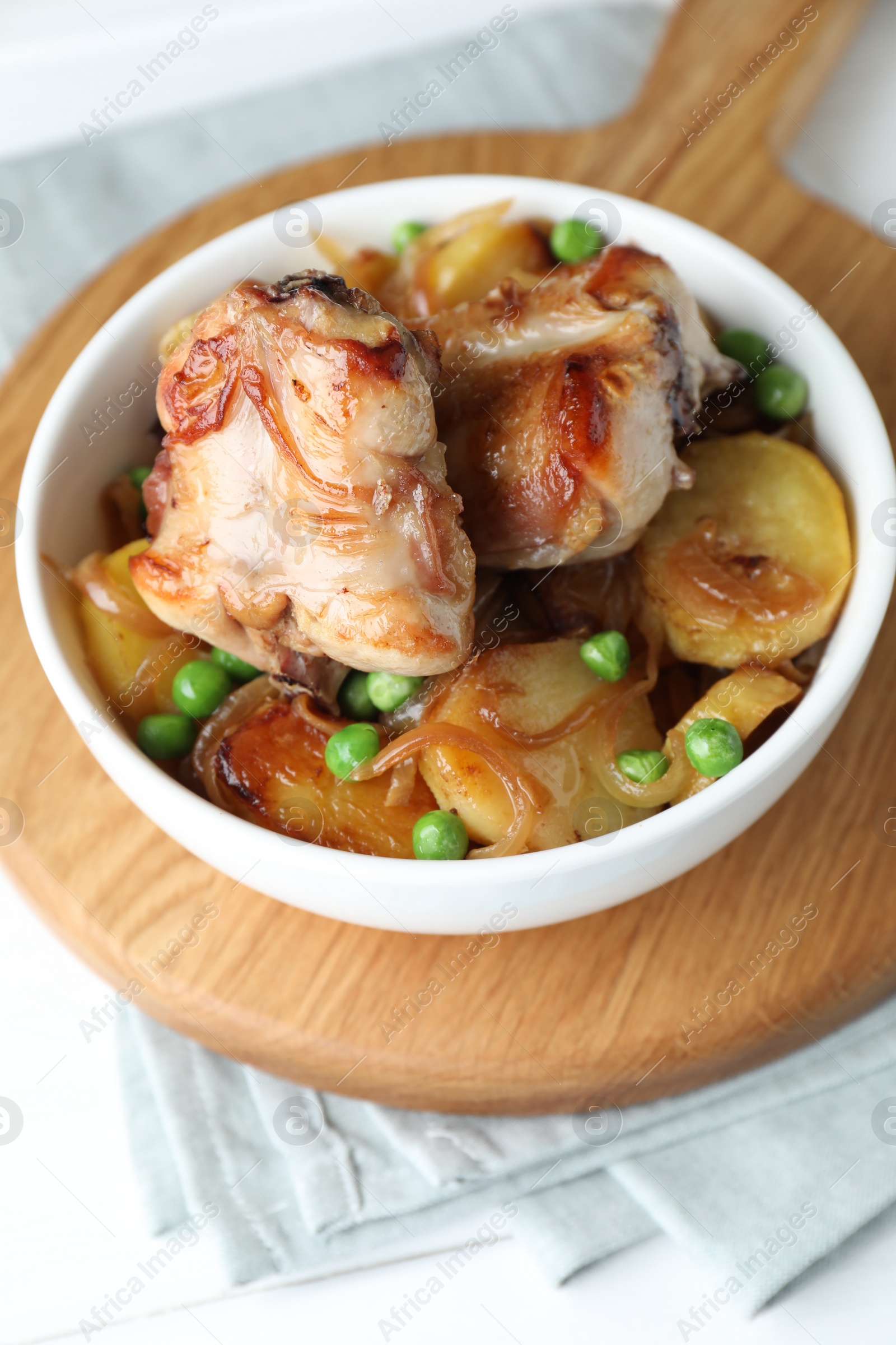 Photo of Tasty cooked rabbit with vegetables in bowl on table, closeup