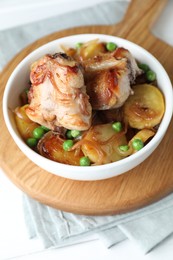 Photo of Tasty cooked rabbit with vegetables in bowl on table, closeup
