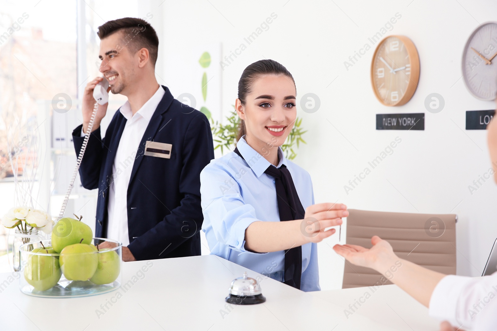 Photo of Busy receptionists at workplace in hotel