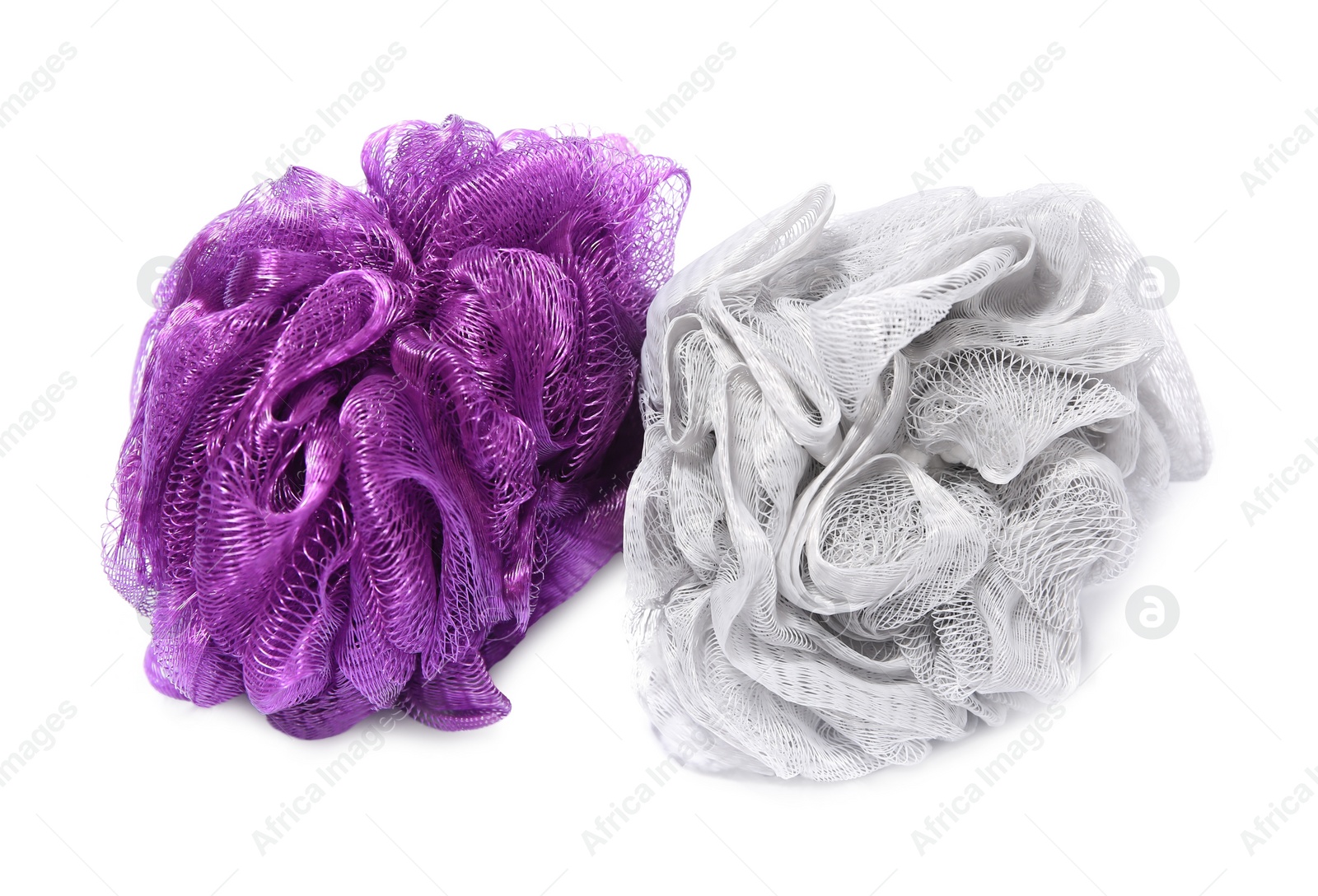 Photo of New shower puffs on white background. Personal hygiene