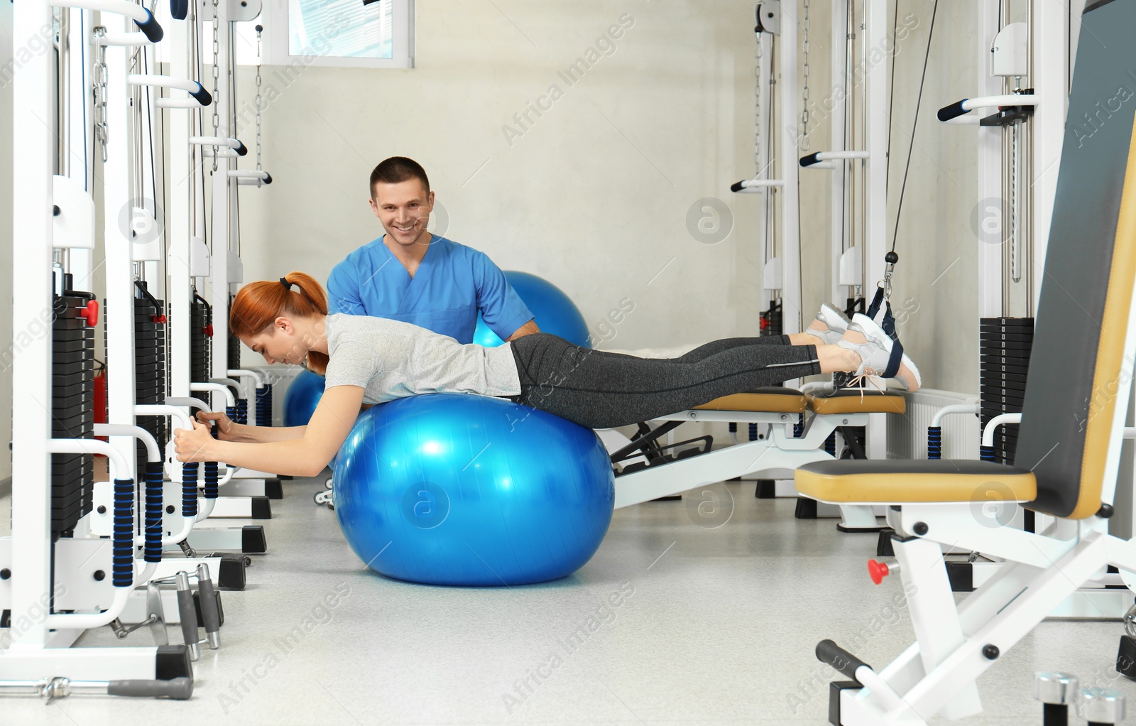 Photo of Patient exercising under physiotherapist supervision in rehabilitation center