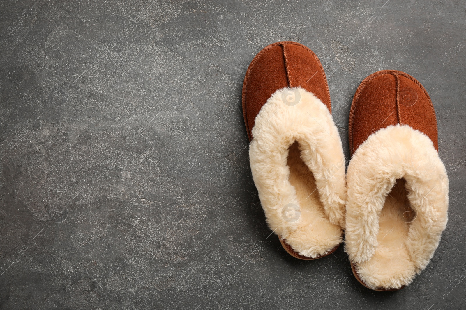 Photo of Pair of stylish soft slippers on grey background, flat lay. Space for text